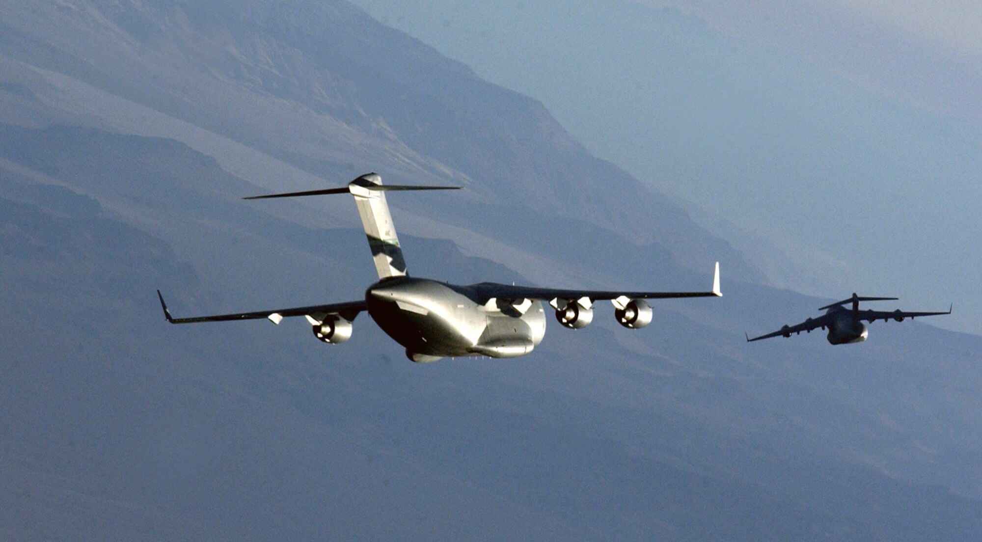 NELLIS AIR FORCE BASE, Nev. -- Two C-17 Globemaster III aircrews prepare for a simulated air drop Dec. 10 during a two-week mission-employment exercise here.  The exercise brought students from the Air Force, Navy and German air force together to learn how their aircraft can integrate during realistic combat scenarios.  This is the first year a C-17 has been included in the exercise.  (U.S. Air Force photo by Tech. Sgt. Kevin Gruenwald)