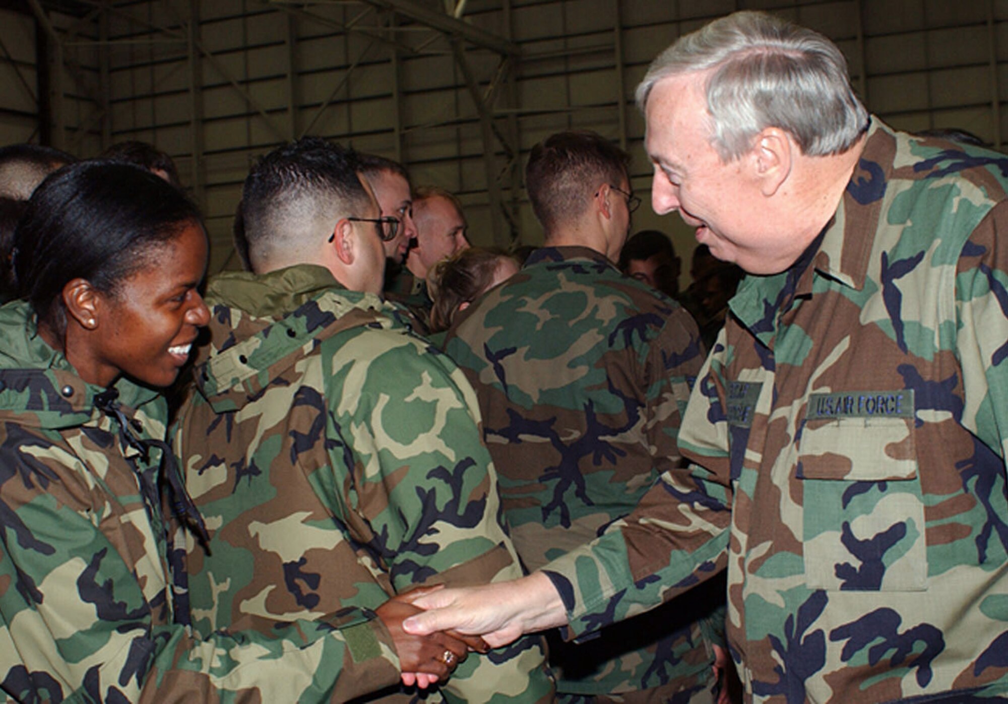 ROYAL AIR FORCE MILDENHALL, England -- Secretary of the Air Force Dr. James Roche shakes hands with Capt. Suzette Knight after he spoke during a troop call here Dec. 11.  Knight is assigned to the 100th Air Refueling Wing legal office here.  (U.S. Air Force photo by Airman 1st Class Stacia Willis)