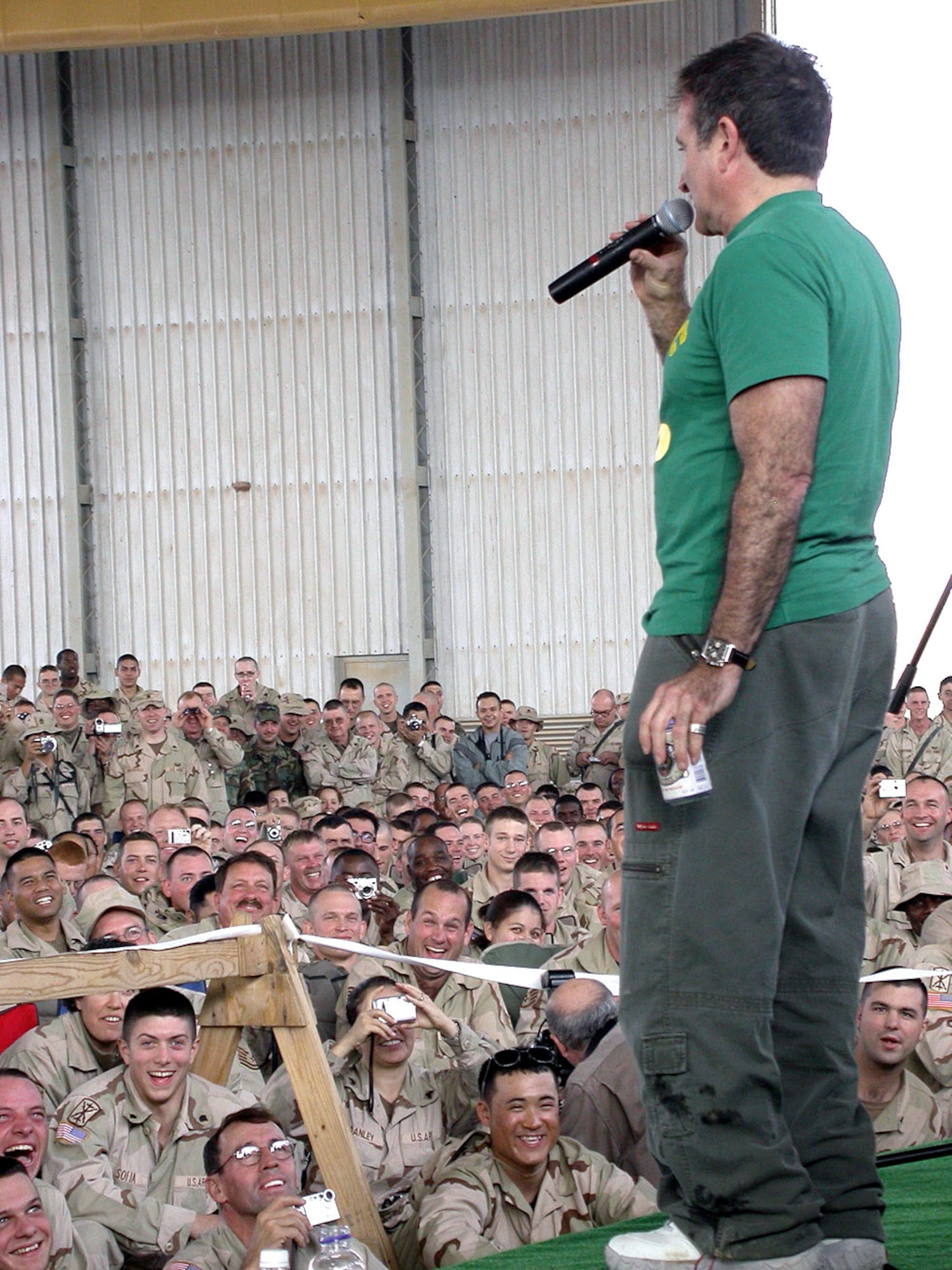 BALAD AIR BASE, Iraq -- Academy Award-winning actor and comedian Robin Williams performs for more than 300 airmen and soldiers deployed here Dec. 18.  Also with him were Olympic gold medalist and professional wrestler Kurt Angle, NASCAR driver Mike Wallace and former model and television personality Leeann Tweeden.  (U.S. Air Force photo by Staff Sgt. A.C. Eggman)