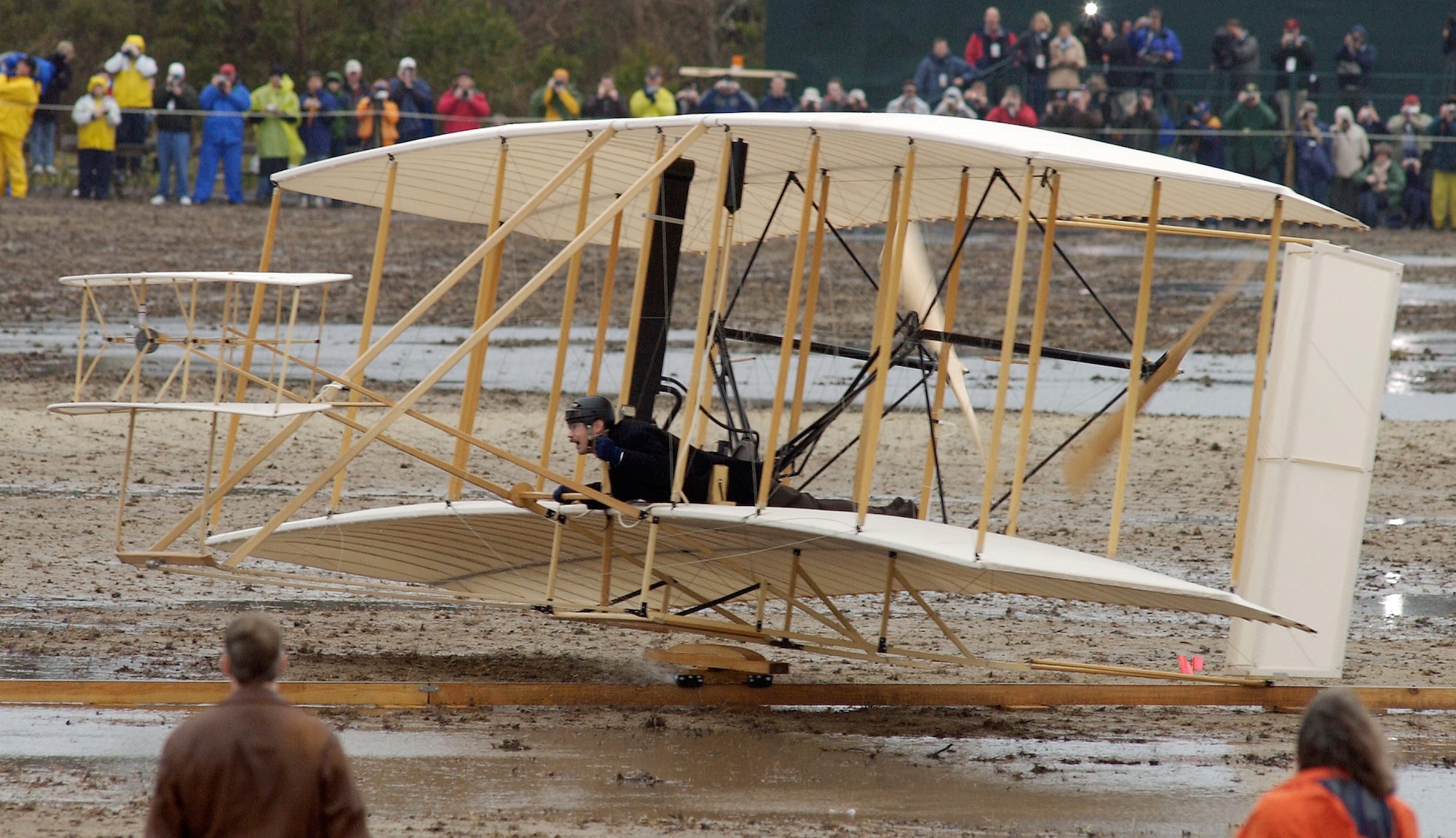 KILL DEVIL HILLS, N.C. -- Pilot Kevin Kochersberger rides a replica of the Wright brothers' original 1903 flyer down a 180-foot rail in his first attempt to re-enact the "12 seconds that changed the world" during the centennial of flight celebration here Dec. 17.  More than 34,000 aviation enthusiasts braved hours of bitter cold and drenching rains at the Wright Brothers National Memorial, hoping to witness the 100th-anniversary re-enactment of the event.  (U.S. Air Force photo by Master Sgt. Jim Varhegyi)