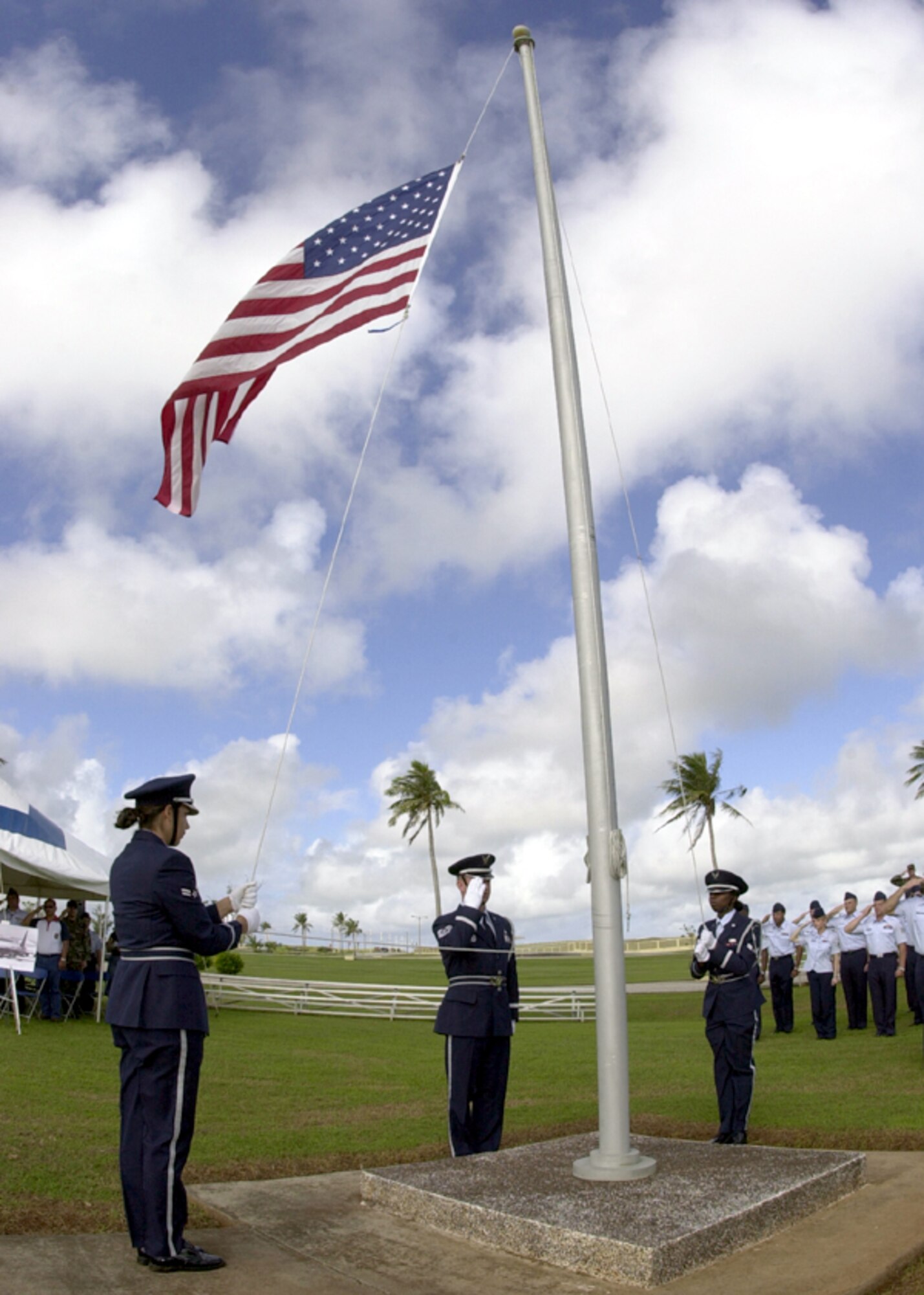 ANDERSEN AIR FORCE BASE, Guam -- Airmen of the Andersen Blue Knights Honor Guard position the flag at half staff during a ceremony here Dec. 18.  The ceremony honored the men lost during the Linebacker II campaign.  (U.S. Air Force photo by Senior Airman Joshua Strang)
