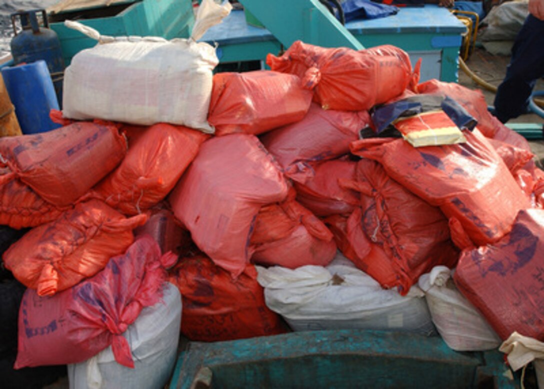 Over 50 bags of hashish are piled on the deck of a dhow intercepted in the Persian Gulf by a U.S. Navy boarding team from the USS Decatur (DDG 73) on Dec. 16, 2003. The team discovered an estimated two tons of narcotics with a street value of around eight to ten million dollars aboard the dhow. The dhow's 12 crewmembers were taken into custody and transferred to USS Decatur, while Decatur sailors took control of the craft and its cargo. 