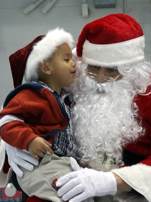 EGLIN AIR FORCE BASE, Fla. -- Three-year-old Ivan Martinez tells Santa what he would like to find in his stocking on Christmas morning.  Children gathered here for the 33rd Fighter Wing family Christmas party Dec. 20.  Ivan is the son of Airman 1st Class Oscar Martinez who is assigned to the 33rd Maintenance Squadron's ammunitions flight.  (U.S. Air Force photo by Tech. Sgt. Cheryl Nolan)
