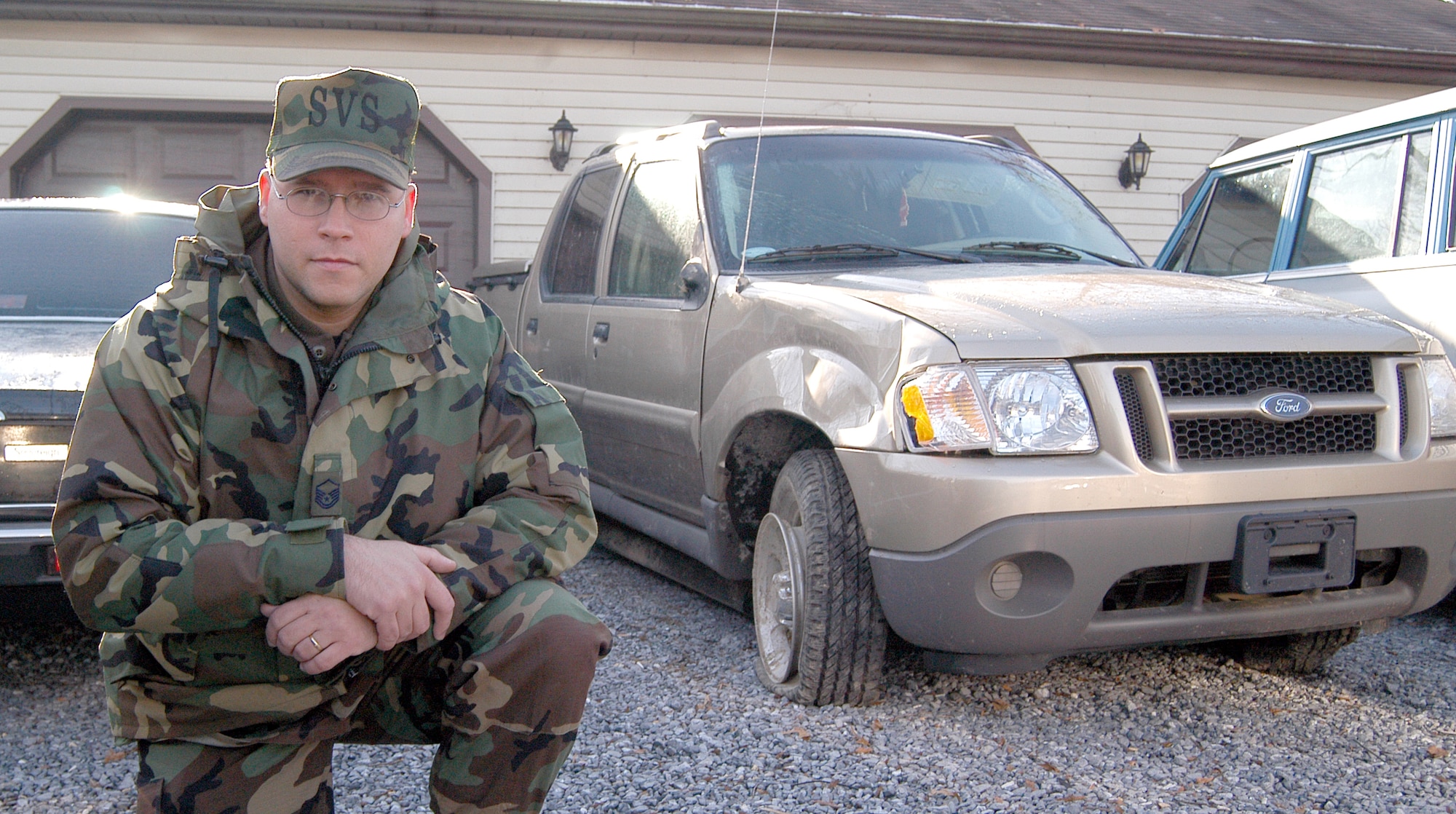 DOVER AIR FORCE BASE, Del. -- Master Sgt. Thomas Dunlap poses near his wrecked pickup, which rolled over three times in an early morning accident recently.  Dunlap, the 436th Services Squadron first sergeant here, said he believes a seatbelt saved his life.  (U.S. Air Force photo by Staff Sgt. Marc Barnes)