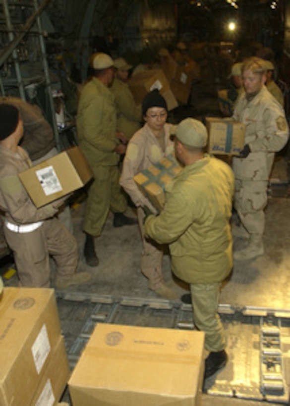 U.S. Central Air Forces C-130 crewmembers and Iranian soldiers offload five pallets containing 20 thousand pounds of medical supplies at Kerman, Iran, on Dec. 28, 2003, two days after a devastating earthquake destroyed the city of Bam, Iran. 