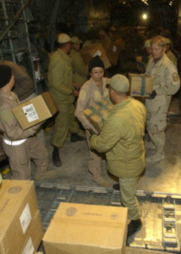U.S. Central Air Forces C-130 crewmembers and Iranian soldiers offload five pallets containing 20 thousand pounds of medical supplies at Kerman, Iran, on Dec. 28, 2003, two days after a devastating earthquake destroyed the city of Bam, Iran. 