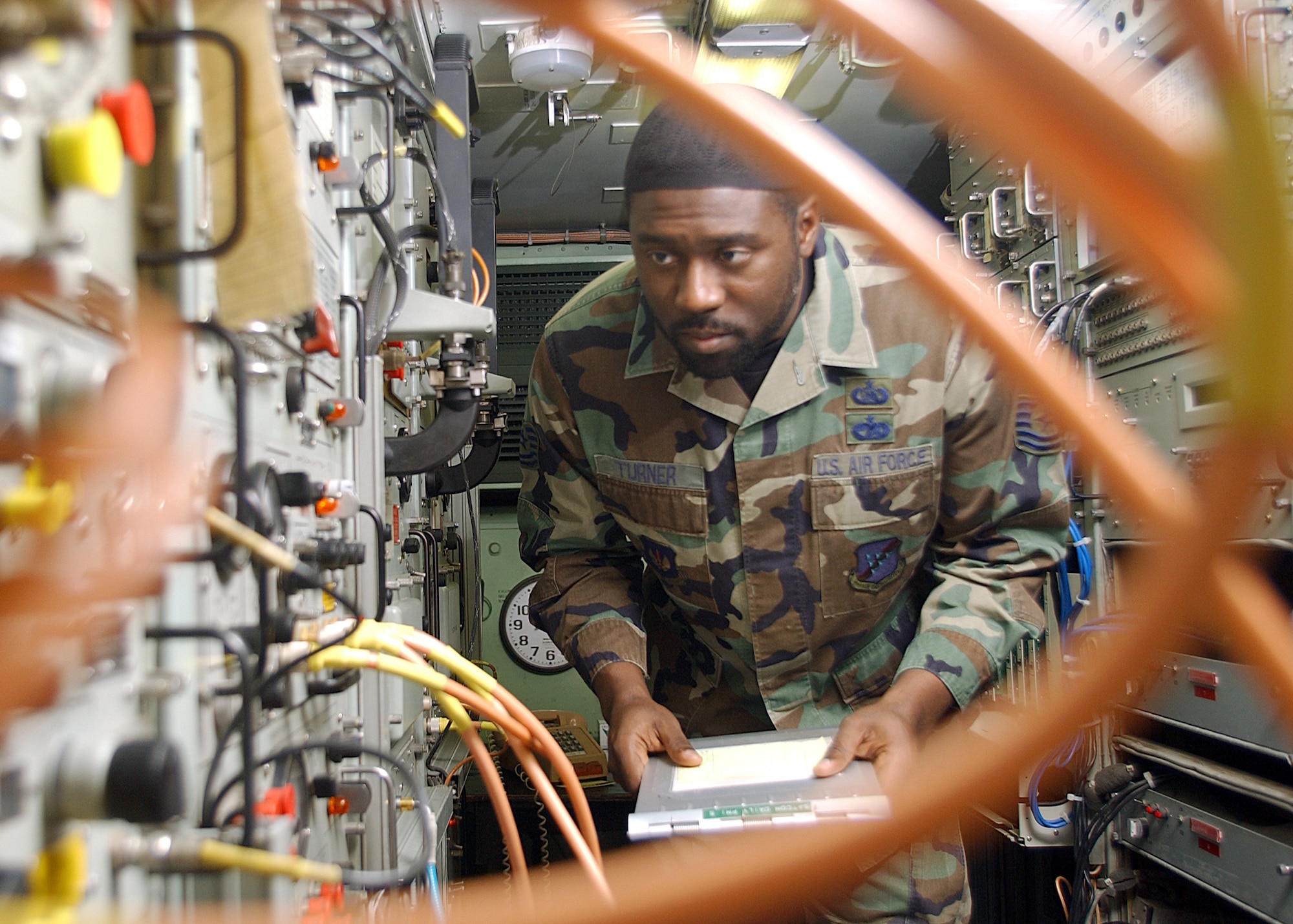 INCIRLIK AIR BASE, Turkey -- Tech. Sgt. Glynis Turner inspects satellite communication equipment here.  During his free time, he is the Islamic lay leader for the base chapel which welcomes all religions.  Turner is a quality assurance evaluator with the 39th Communications Squadron.  (U.S. Air Force photo by Airman 1st Class Joseph Thompson)