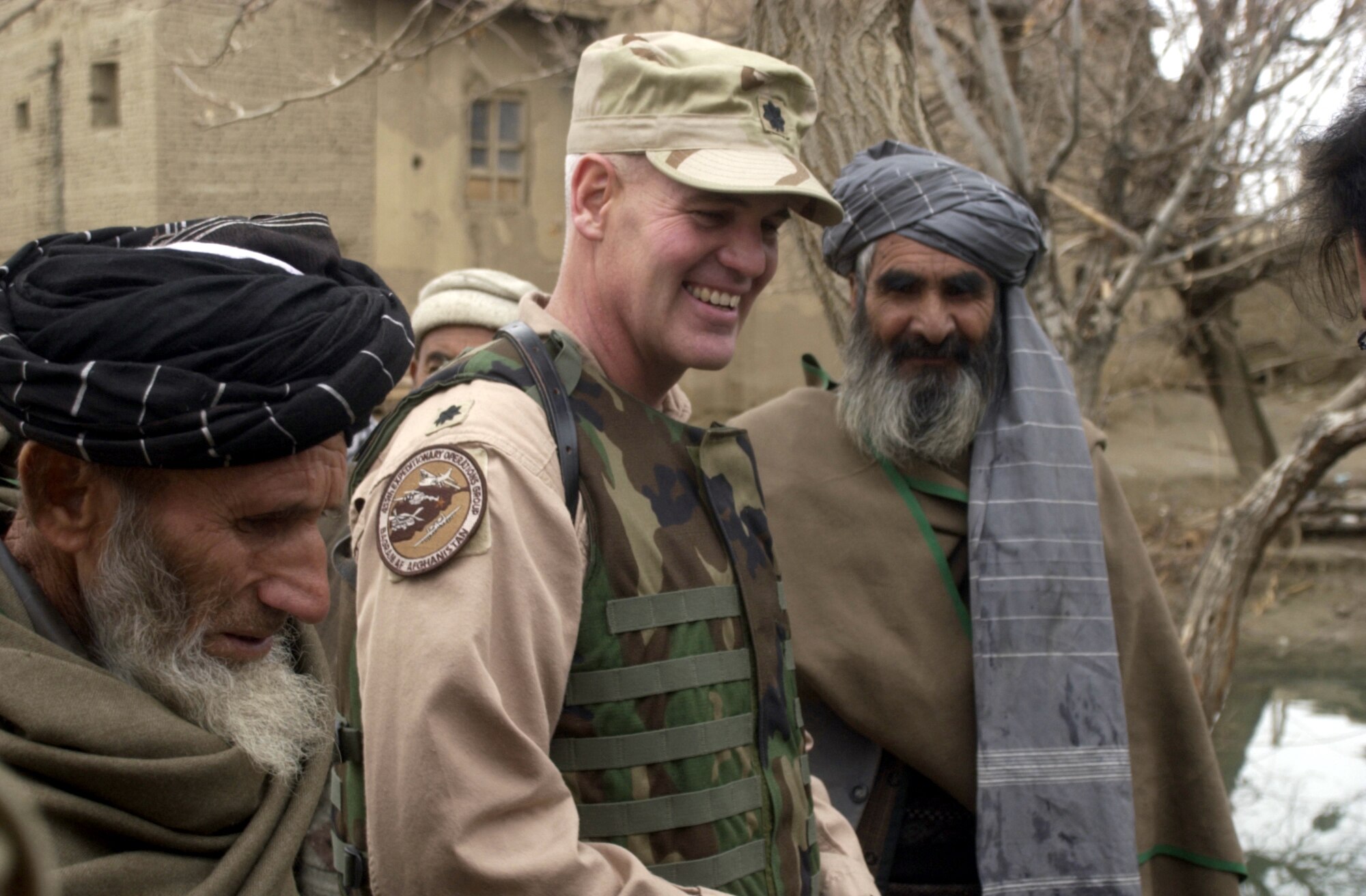 JANGADAM VILLAGE, Afghanistan -- Lt. Col. John Bernier meets with village elders here during the 455th Expeditionary Operations Group's delivery of humanitarian supplies Dec. 31.  Bernier is the 455th Air Expeditionary Wing flight safety officer.  (U.S. Air Force photo by Tech. Sgt. Brian Davidson)