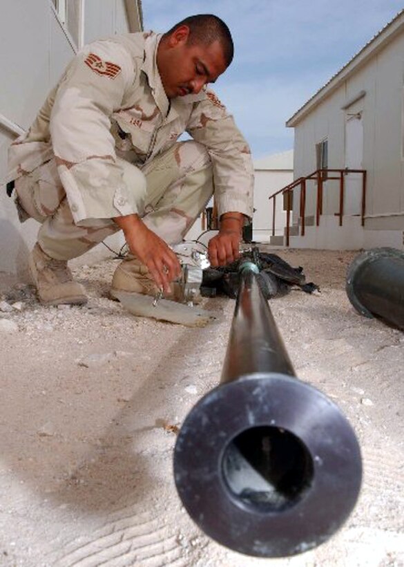 SOUTHWEST ASIA - Staff Sgt. Juan Lara prepares an antenna bracket for installation on the new operations group building at a forward-deployed location Dec. 28.  Sergeant Lara is a ground radio technician assigned to the 379th Expeditionary Communications Squadron.  (U.S. Air Force photo by Airman 1st Class Nichole Adamowicz)