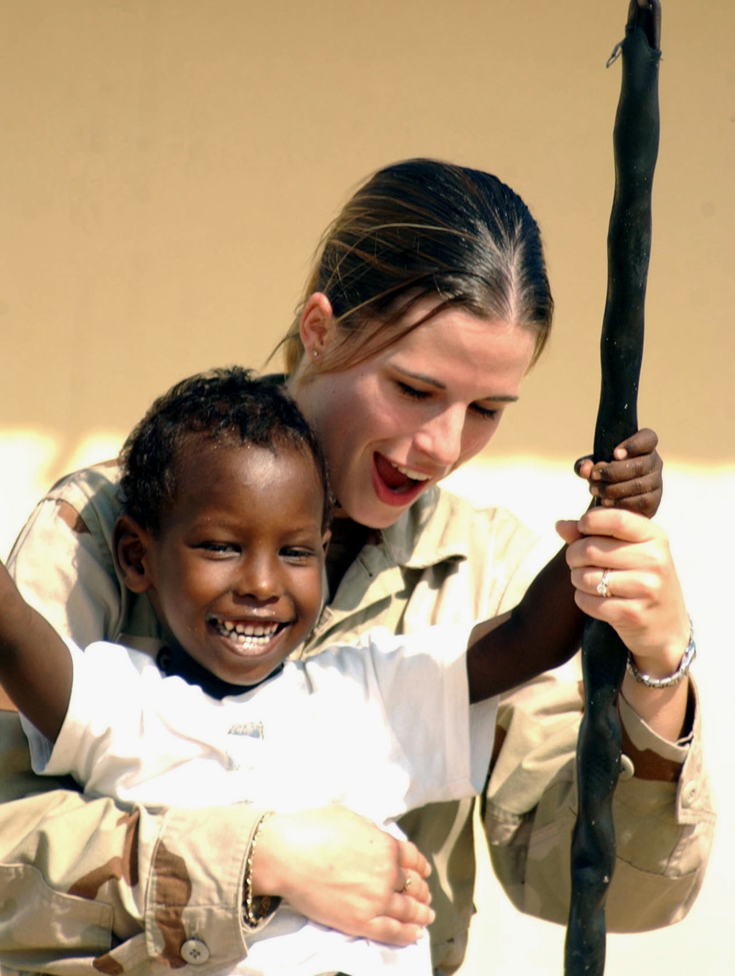 DJIBOUTI CITY, Djibouti -- Senior Airman Jamie Grampp spends some time with a child at an orphanage in Djibouti City, Djibouti. Grampp is a finance clerk with Combined Joint Task Force-Horn of Africa. She is deployed from the 436th Comptroller Squadron at Dover Air Force Base, Del. (U.S. Air Force photo by Marine Corps Cpl. Paula M. Fitzgerald)