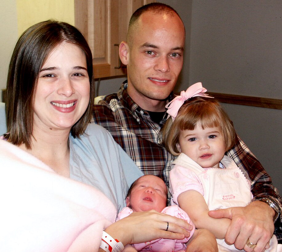 LACKLAND AIR FORCE BASE, Texas -- Jessica, Mary, Rachel and Brent Decker pose for a family picture in Wilford Hall's birth center at Lackland Air Force Base, Texas. Mary was born Jan. 30 -- healthy -- despite being given a 1 percent chance of surviving in the womb. (U.S. Air Force photo by Sue Campbell)