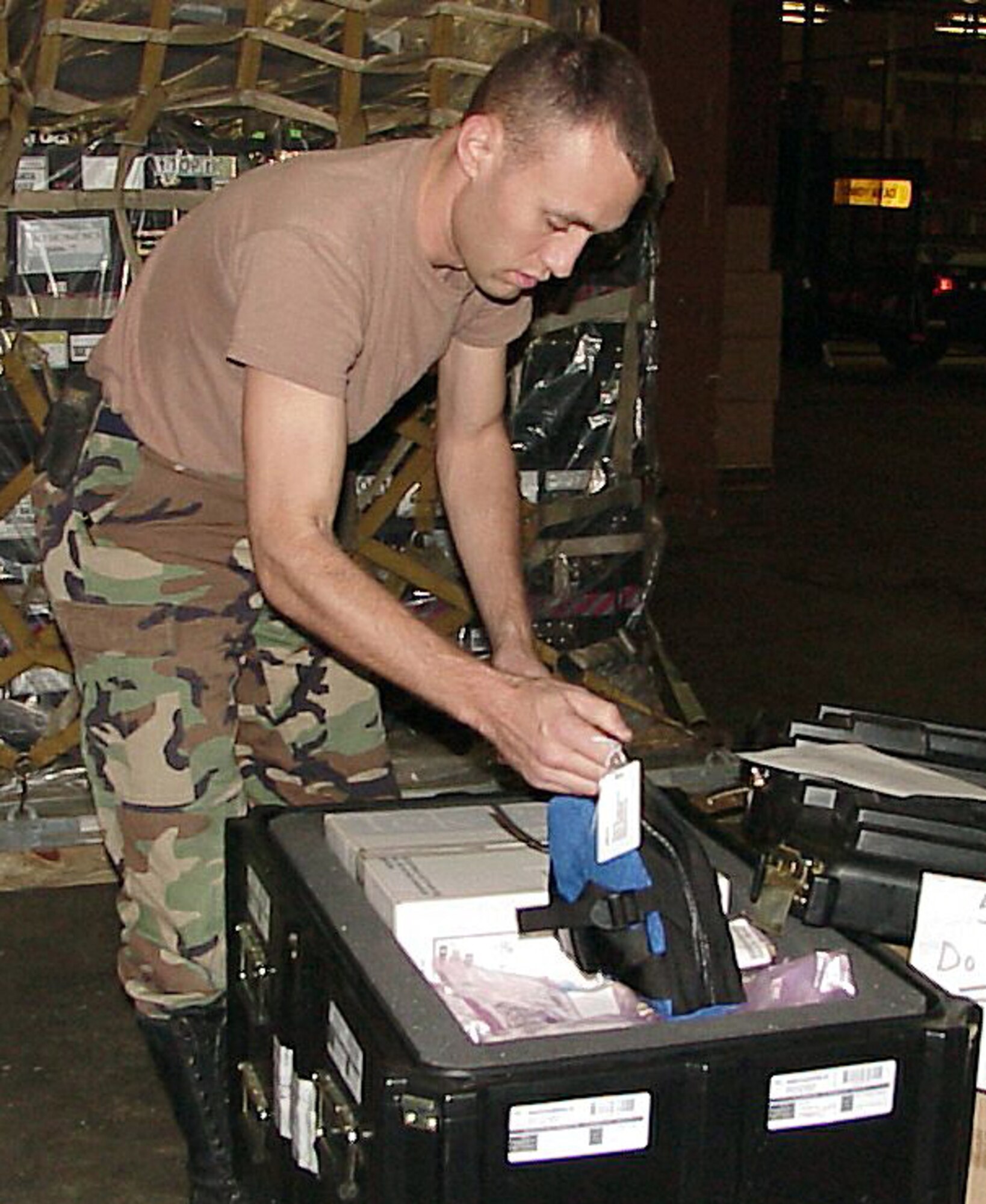 ROBINS AIR FORCE BASE, Ga. -- Staff Sgt. Ian Powell checks a fiber optic repair kit before putting it on a pallet. Powell is assigned to the 54th Combat Communications Squadron at Robins Air Force Base, Ga. The 54th CCS is part of the 5th Combat Communications Group which received orders to deploy to the U.S. Central Command theater of operations. (U.S. Air Force photo by Staff Sgt. Adam Stump)