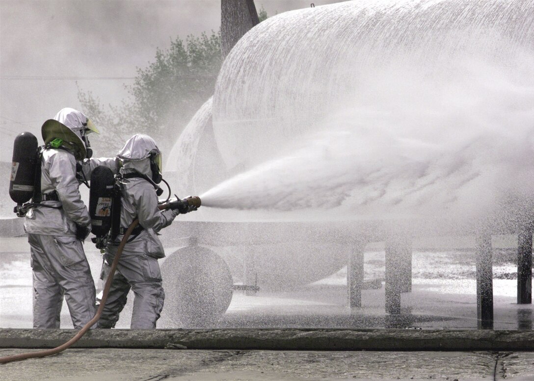 ELLSWORTH AIR FORCE BASE, S.D. -- Firefighters extinguish a fire on a simulated B-1 at the base training grounds here on May 15, 2001. (U.S. Air Force photo by Airman 1st Class Nathaniel G. Bevier)
