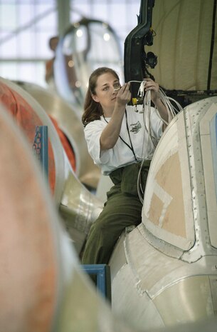 1990's -- HILL AIR FORCE BASE, Utah -- Shauna Sullins installs a wire harness in an A-10 Thunderbolt II. She works in "Hog Heaven," the A-10 production section of the aircraft directorate at the Ogden Air Logistics Center here. She said work on the home front will be vital in the war against terrorism.
(U.S. Air Force photo by Tech. Sgt. Lance Cheung)
