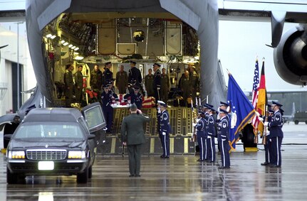 RAMSTEIN AIR BASE, Germany -- Members of the 86th Airlift Wing Honor Guard carry the remains of fallen sailors from the USS Cole out of a C-17 Globemaster III here, Oct.13, 2001. The Navy destroyer was in the port of Aden, Yemen, when the incident occurred. (U.S. Air Force photo by Master Sgt. Keith Reed)
