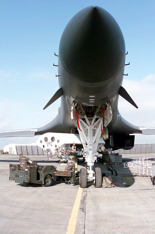 ROYAL AIR FORCE FAIRFORD, England -- A munitions load crew places a conventional module bomb rack onto a B-1B Lancer long-range strategic bomber here. B-1B Lancers and support personnel from the 28th Bomb Wing at Ellsworth Air Force Base, S.D., are deployed  supporting Operation Allied Force. (U.S. Air Force photo by Staff Sgt. Randy Mallard)