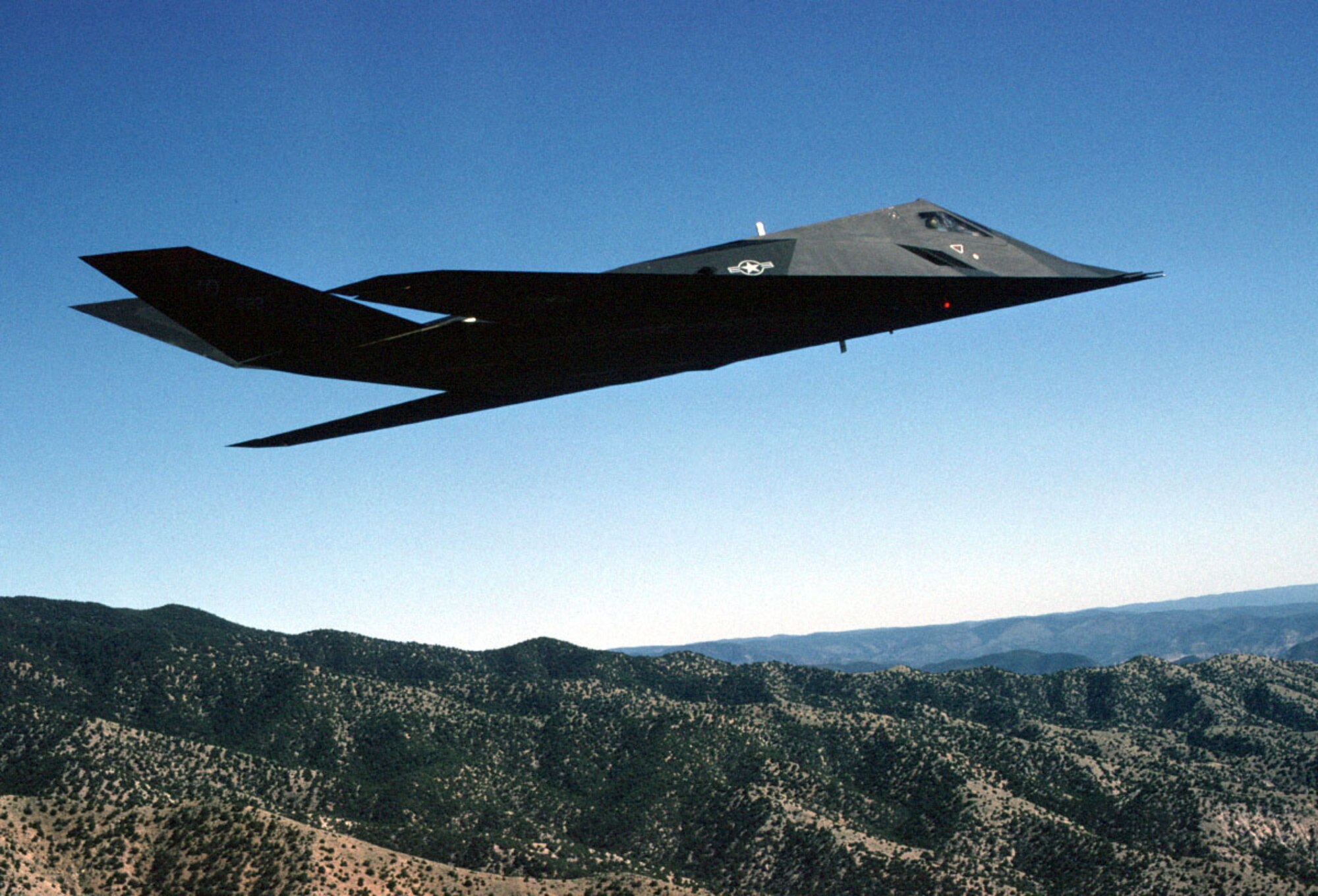 NEW MEXICO -- The F-117A Nighthawk Stealth fighter from the 49th Fighter Wing, 9th Fighter Squadron "Iron Knights," from Holloman Air Force Base, N.M. Flies a training mission over the New Mexico desert. The F-117 is the world's first operational aircraft designed to exploit low-observable stealth technology. The unique design of the single-seat F-117A provides exceptional combat capabilities. Air refuelable, it supports worldwide commitments and adds to the deterrent strength of the U.S. military forces. The F-117A can employ a variety of weapons and is equipped with sophisticated navigation and attack systems integrated into a state-of-the-art digital avionics suite that increases mission effectiveness and reduces pilot workload.  (U.S. Air Force Photo by Staff Sgt. Andy Dunaway)