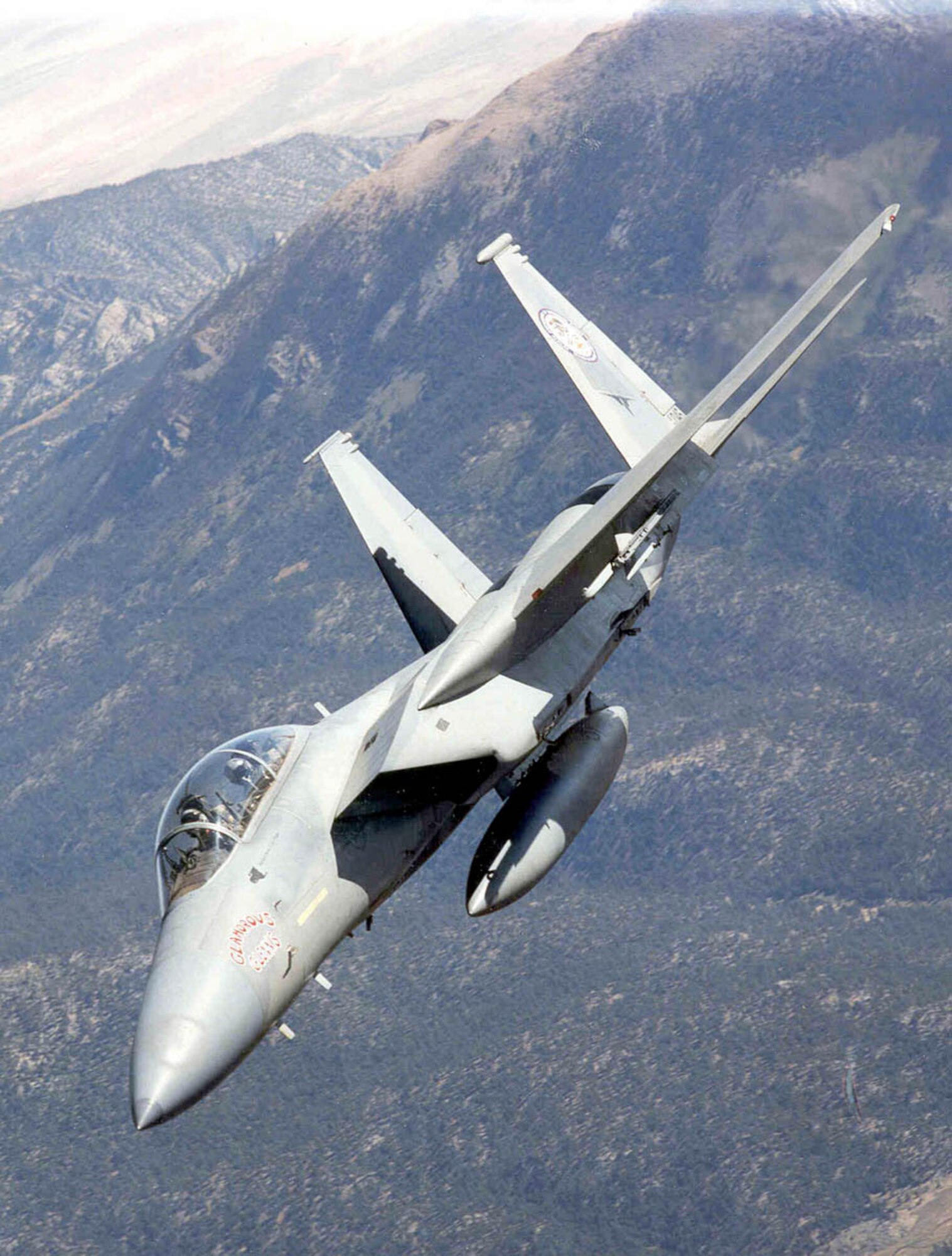 EDWARDS AIR FORCE BASE, Calif. -- An F-15 Eagle from the 445th Flight Test Squadron here banks over mountains in the Sequoia National Forest. The F-15 was flying as a chase aircraft during recent B-1B bomber tests. Throughout the years, Edwards has evaluated the world's current premier air superiority fighter for engine enhancements, radar improvements and weapons additions.(U.S. Air Force photo by George Rolhmaller)