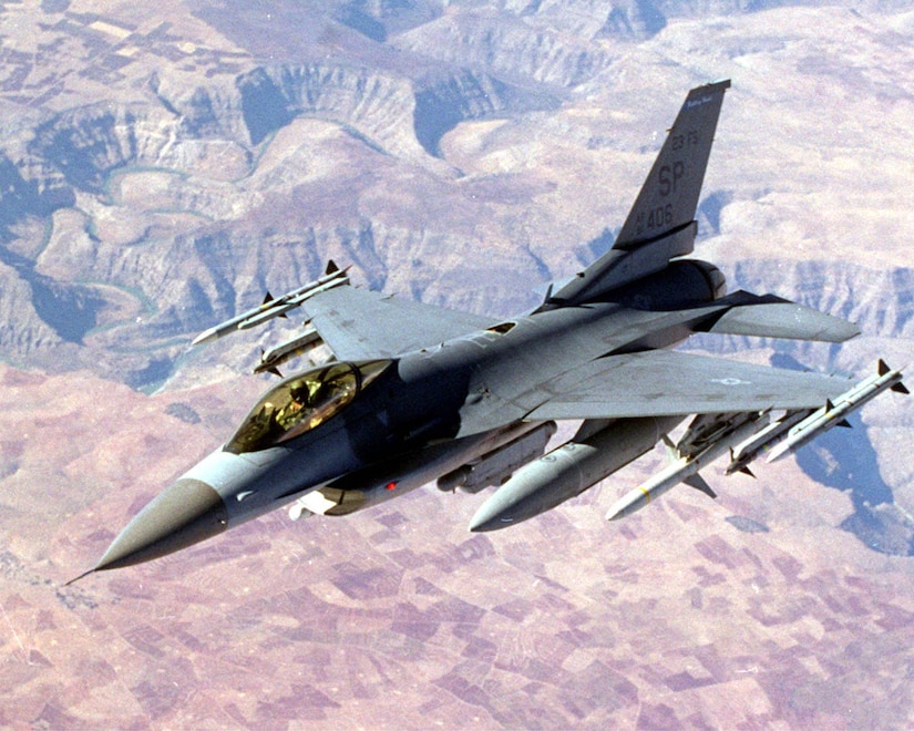 FILE PHOTO  -- An F-16 Fighting Flacon cruises over the landscape. (U.S. Air Force photo) 