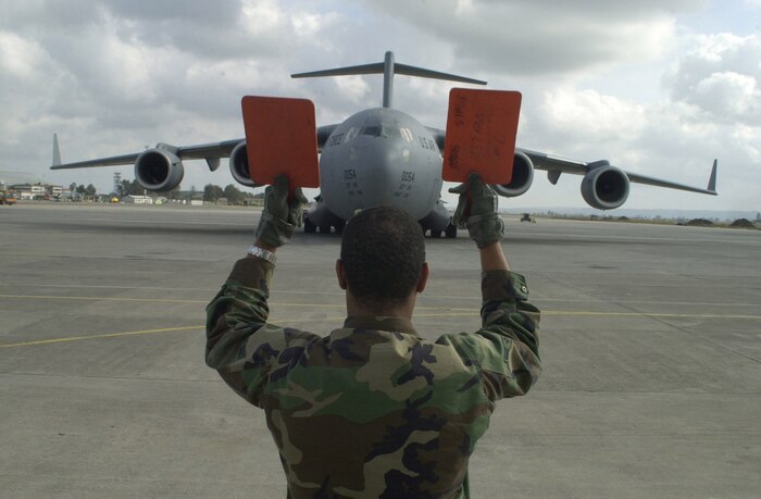 OPERATION ENDURING FREEDOM -- Airman 1st Class Scott McCormrick from the 437th Aircraft Generation Squadron at Charleston Air Force Base, S.C., marshals in a C-17A Globemaster III at an operating location in support of the U.S. Central Command execution of Operation Enduring Freedom on Nov. 16.  (U.S. Air Force photo by Staff Sgt. Ken Bergmann)