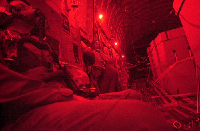 OPERATION ENDURING FREEDOM -- U.S. Air Force crew members from Charleston Air Force Base, S.C., continue high altitude drops of HDRs (Humanitarian Daily Rations) from their C-17 Globemaster III somewhere over northern Afghanistan, Oct. 18. The C-17 dropped 42 TRIADS containing 17,220 HDRs. More than 500,000 HDRs have been dropped into Afghanistan since the humanitarian relief effort began.(U.S. Air Force photo by Mannie Garcia/Gannett/ATPCo) 