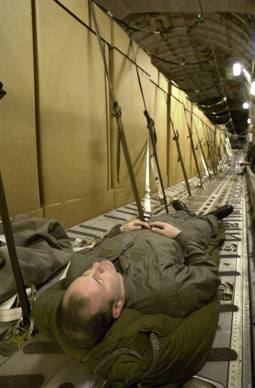 OPERATION ENDURING REEDOM -- A U.S. Air Force crew member from Charleston Air Force Base, S.C., takes a nap before continueing high altitude drops of HDRs (Humanitarian Daily Rations) from their C-17 Globemaster III somewhere over northern Afghanistan, Oct, 18, 2001. The C-17 dropped 42 TRIADS containing 17,220 HDRs. More than 500,000 HDRs have been dropped into Afghanistan since the humanitarian relief effort began. (U.S. Air Force photo by Mannie Garcia/Gannett/ATPCo)
