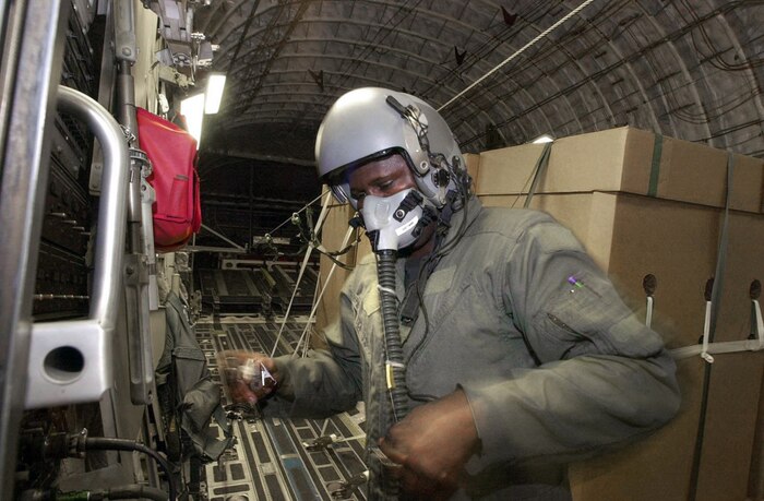 OPERATION ENDURING FREEDOM -- U.S. Air Force Loadmaster "Chris" checks his high altitude oxygen equipment. U.S. Air Force crew members from Charleston Air Force Base, S.C., continue to drop HDRs (Humanitarian Daily Rations) from their C-17 Globemaster III somewhere over northern Afghanistan, Oct. 18. The C-17 dropped 42 TRIADS containing 17,220 HDRs. Approximately 450,000 HDRs have been dropped into Afghanistan since the humanitarian relief effort began. (U.S. Air Force photo by Mannie Garcia/Gannett/ATPCo)
