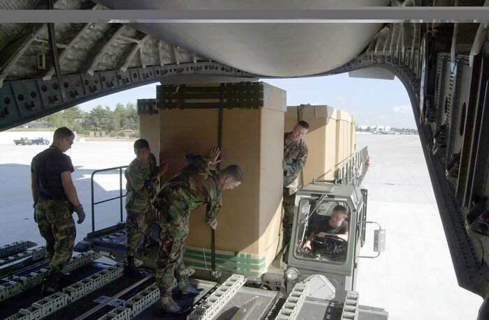 OPERATION ENDURING FREEDOM -- Soldiers from the 5th Quartermasters Company, Rhine Ordinance Barracks, Germany, help load a C-17 transport plane with Tri-Wall Aerial Delivery (TRIAD) containers full of humanitarian daily rations Oct. 10, 2001 at Ramstein Air Base, Germany. The C-17 Globemaster III, from Charleston Air Force Base, S.C., is supporitng Operation Enduring Freedom with humanitarian relief airdrops over Afghanistan.  (U.S. Air Force photo)  