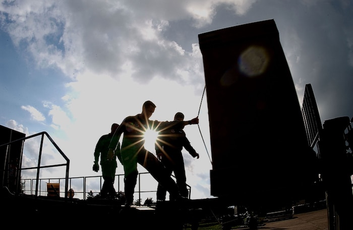 RAMSTEIN AIR BASE, Germany -- Airmen containerize humanitarian daily rations Oct. 4 before they are placed on board a C-17 Globemaster III. The humanitarian supplies were airdropped Oct. 7 over eastern Afghanistan as part of Operation Enduring Freedom. (U.S. Air Force photo by Staff Sgt. Jeremy Lock)
