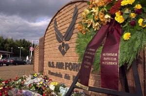RAMSTEIN AIR BASE, Germany -- Flowers, candles and letters were left at the Ramstein gate by German neighbors and supporters, including Ramstein-Miesenbach mayor Klaus Layes. People around the world paid tribute to those killed in the terrorist attack in New York City and in Washington, D.C,. on Sept. 11. (Courtesy photo) 