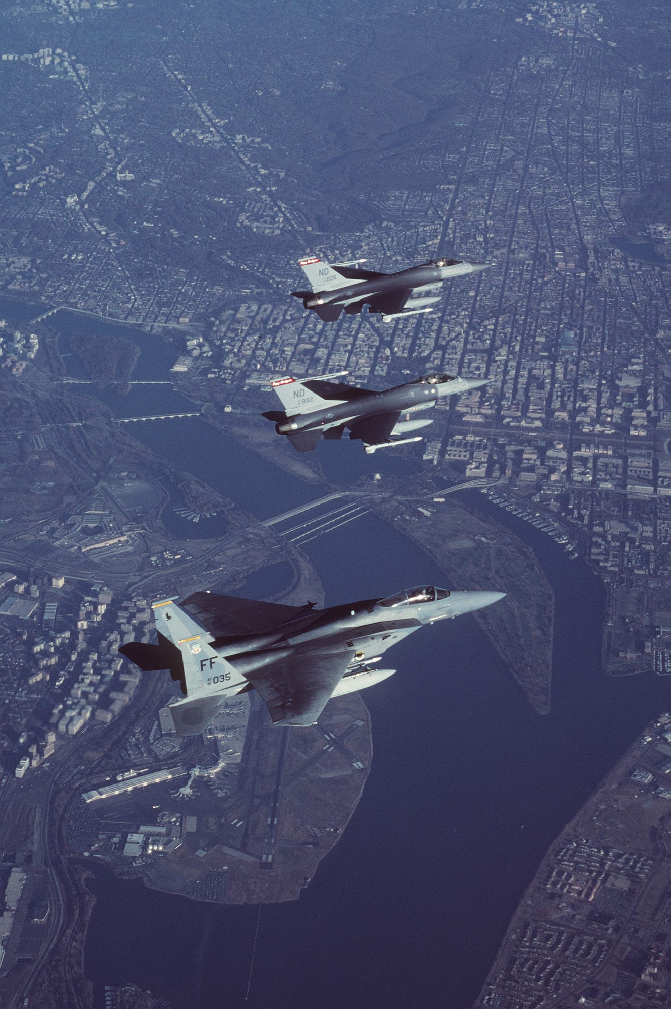Two Air-Defense Fighter F-16A Fighting Falcons from the North Dakota Air National Guard’s 178th Fighter Squadron lead an F-15C Eagle from the 27th Fighter Squadron at Langley Air Force Base, Va., in formation during a combat air patrol mission in support of Operation Noble Eagle. More than 11,000 airmen -- the majority Air National Guard and Air Force Reserve -- have generated more than 7,500 sorties to patrol American skies 24/7 since Sept. 11, 2001. (U.S. Air Force photo by Staff Sgt. Greg L. Davis)