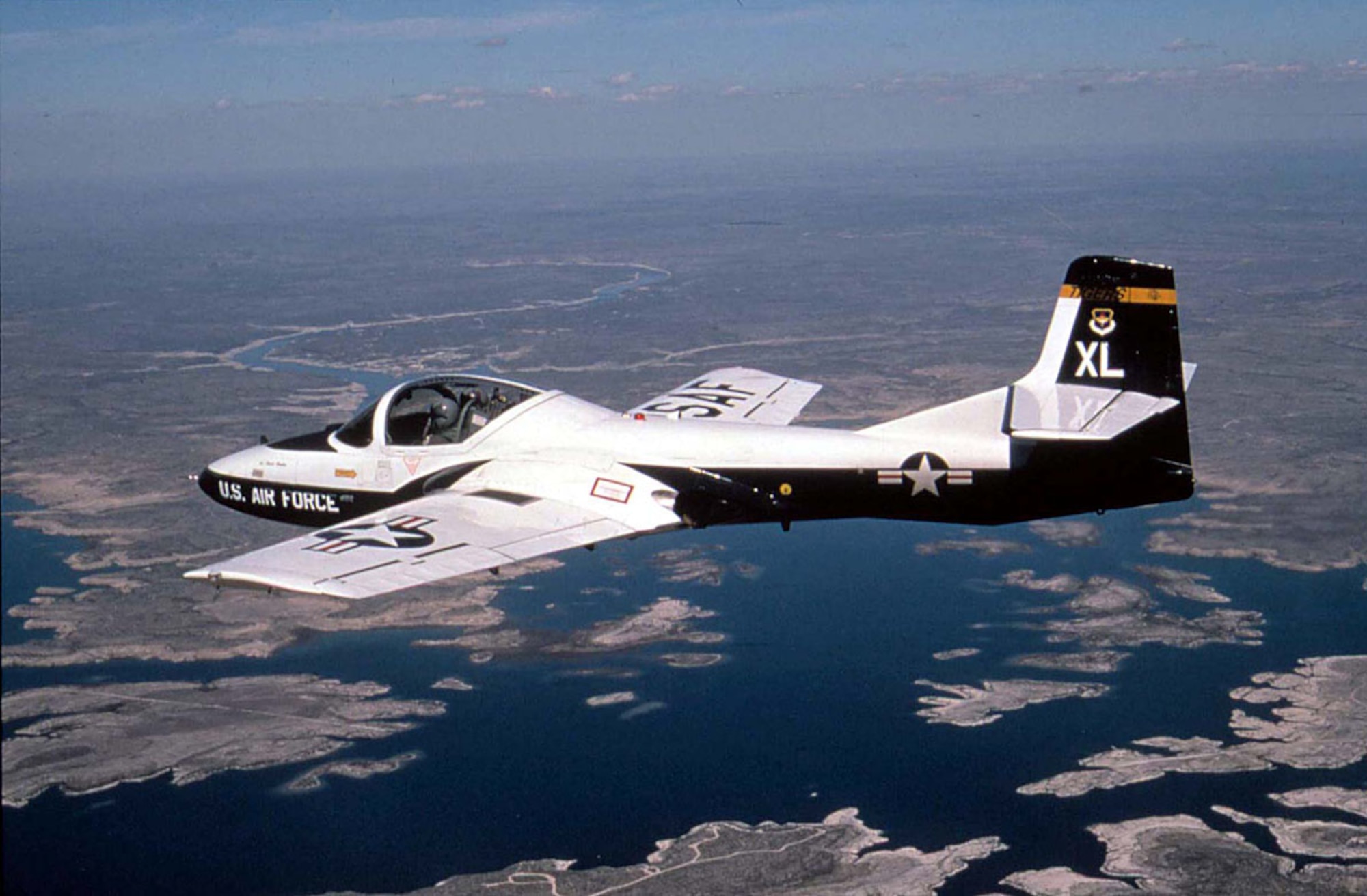 FILE PHOTO -- A T-37 Tweet aircraft from the 85th Fighter Training Squadron, Laughlin AFB, Texas, flies over Lake Amistad during a training mission. The T-37 Tweet is a twin-engine jet used for training undergraduate pilots, undergraduate navigator and tactical navigator students in fundamentals of aircraft handling, and instrument, formation and night flying. The twin engines and flying characteristics of the T-37 give student pilots the feel for handling the larger, faster T-38 Talon or T-1A Jayhawk later in the undergraduate pilot training course. The instructor and student sit side by side for more effective training. The cockpit has dual controls, ejection seats and a clamshell-type canopy that can be jettisoned. (Air Force photo by Staff Sgt. Andy Dunaway) 