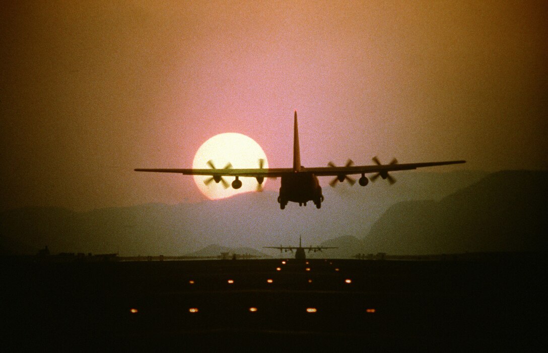 CLARK AIR BASE, Phillippines -- Silhouetted by the setting sun, a C-130 Hercules aircraft prepares to land during a 10-ship air drop exercise being conducted by the 21st Tactical Airlift Squadron, 374th Tactical Airlift Wing. (U.S. Air Force photo by Staff Sgt. Daniel C. Perez.)