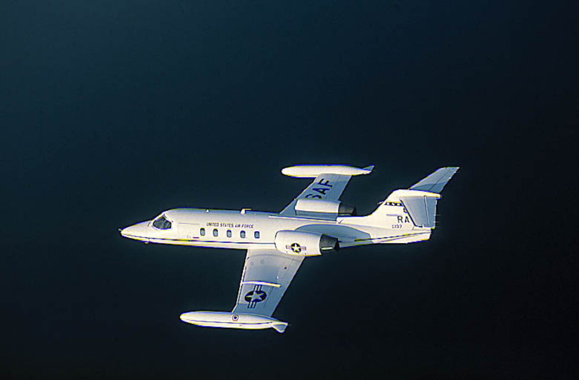 FILE PHOTO -- The C-21A provides cargo and passenger airlift and can transport litters during medical evacuations. The C-21A's turbofan engines are pod-mounted on the sides of the rear fuselage. The swept-back wings have hydraulically actuated, single-slotted flaps. The aircraft has a retractable tricycle landing gear, single steerable nose gear and multiple-disc hydraulic brakes. The C-21A can carry eight passengers and 42 cubic feet (1.26 cubic meters) of cargo. The fuel capacity ofthe C-21A is 931 gallons (3,537.8 liters) carried in wingtip tanks. The safety and operational capabilities of the C-21A areincreased by the autopilot, color weather radar and tactical air navigation (TACAN) system, as well as HF, VHF and UHF radios. (U.S. Air Force photo)

