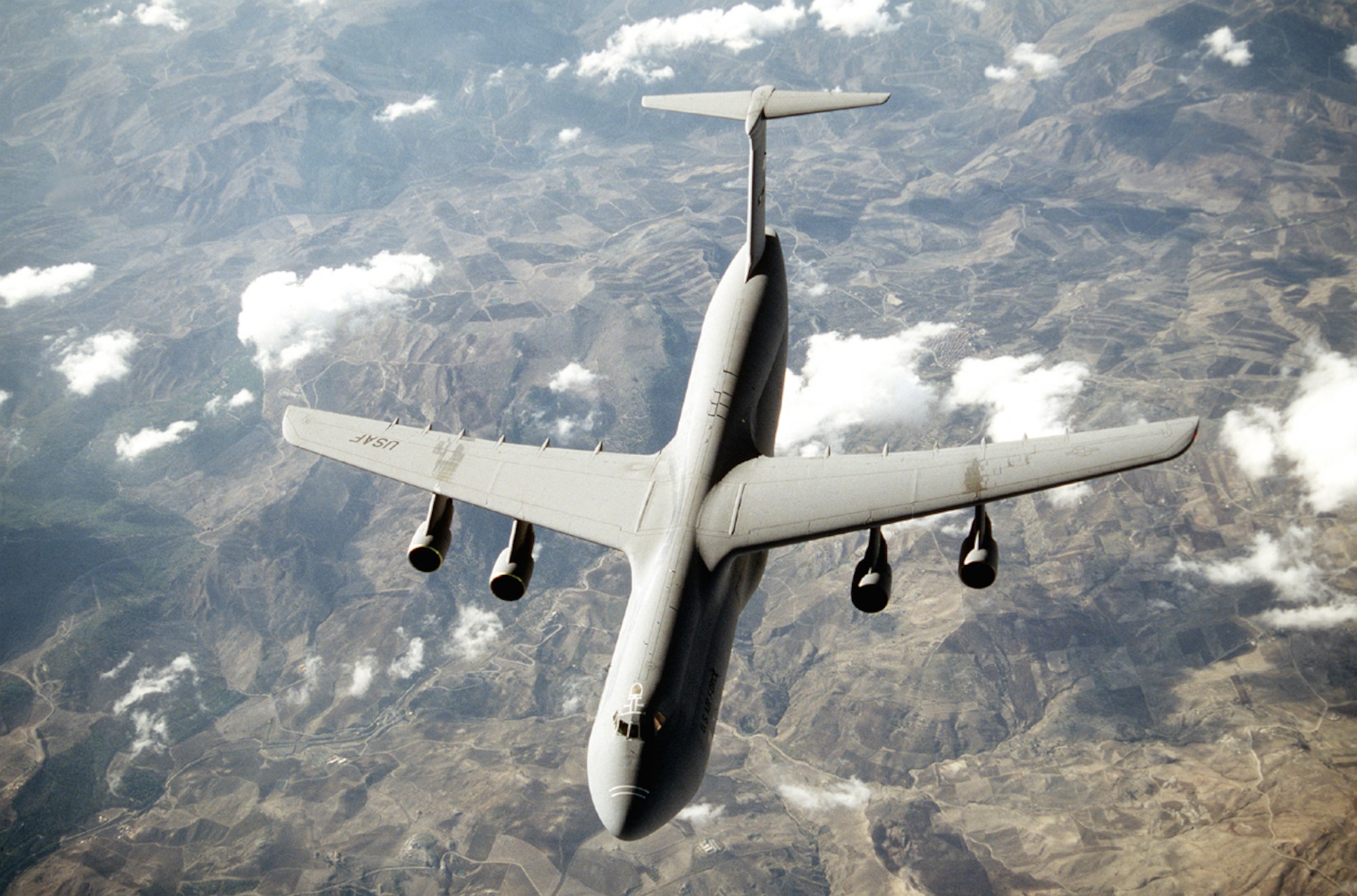 FILE PHOTO -- With its tremendous payload capability, the C-5 Galaxy, an outsized-cargo transport, provides the Air Mobility Command intertheater airlift in support of United States national defense. The C-5 is one of the largest aircraft in the world. It can carry outsized cargo intercontinental ranges and can take off or land in relatively short distances. Ground crews can load and off load the C-5 simultaneously at the front and rear cargo openings since the nose and aft doors open the full width and height of the cargo compartment. It can also "kneel down" to facilitate loading directly from truck bed levels. (U.S. Air Force photo by Brett Snow) 
