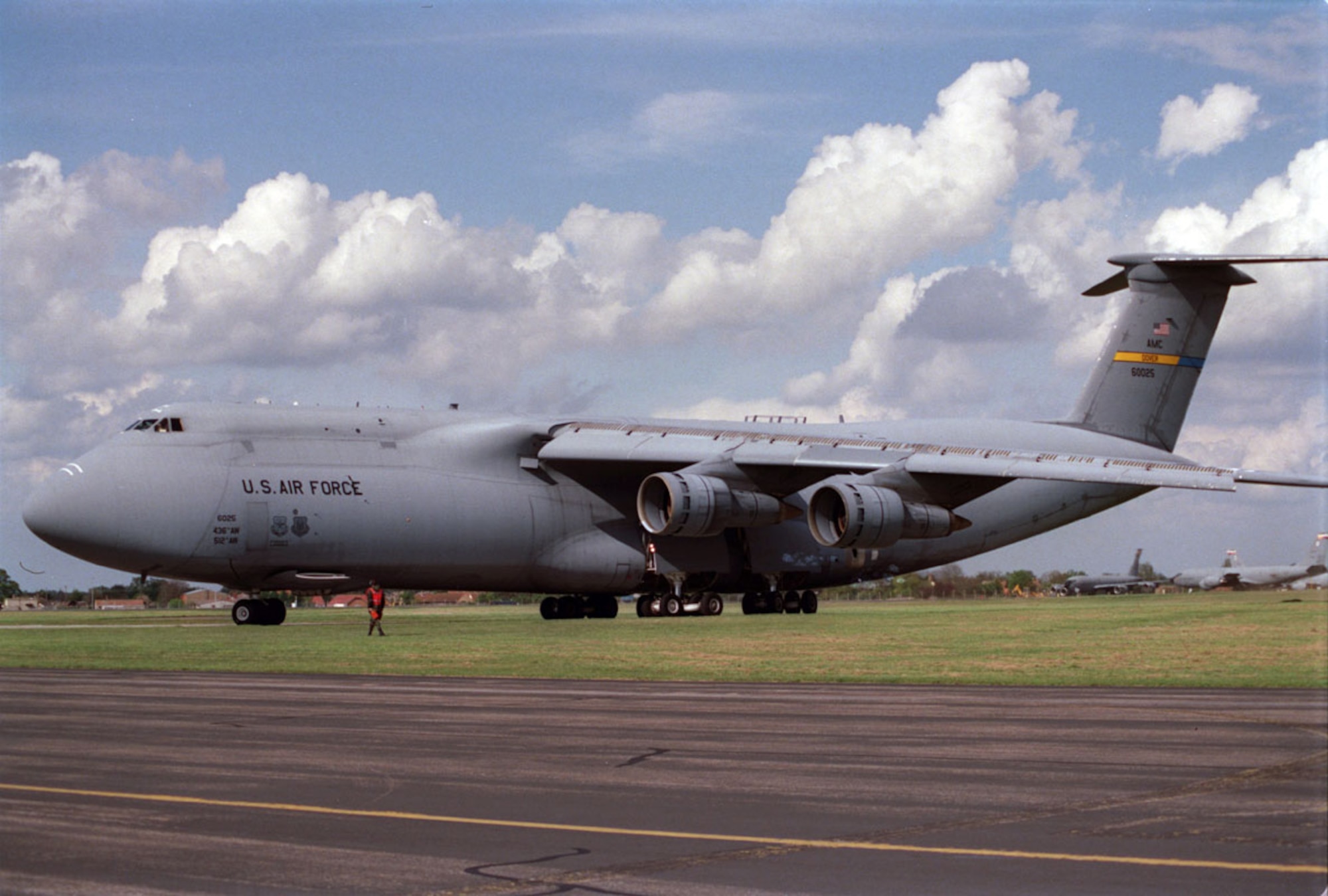 ROYAL AIR FORCE, MILDENHALL, England -- A Force C-5 Galaxy arrives at here, April 22, 1999. The C-5 is delivering four fuel trucks to help the fuels management flight of the 100th Supply Squadron keep up with the increasing demand to fuel more KC-135R Stratotankers for Operation Allied Force. (U.S. Air Force photo by Tech. Sgt. Brad Fallin)
