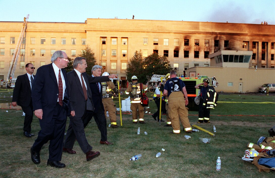 WASHINGTON -- Secretary of Defense Donald H. Rumsfeld (center) leads Sen. Carl Levin (left), D-Mich. and Sen. John Warner (right), R-Va., to the crash scene at the Pentagon heliport on Sept. 11, 2001.  Rumsfeld earlier conducted a news conference with reporters in the Pentagon briefing room on the terrorist attack of the Pentagon.  (DOD photo by Helene C. Stikkel) 