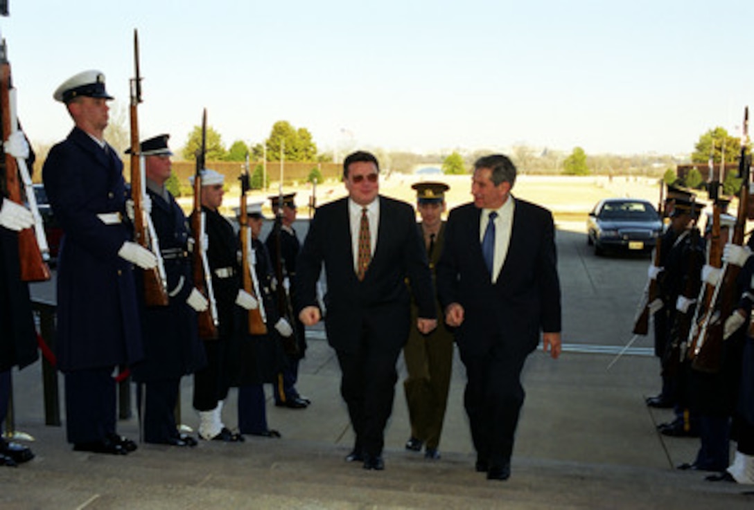 Deputy Secretary of Defense Paul Wolfowitz (right) escorts Lithuanian Minister of Defense Linas Linkevicius through an honor cordon and into the Pentagon on Feb. 5, 2003. The two defense leaders will meet to discuss a range of bilateral and regional security issues. 