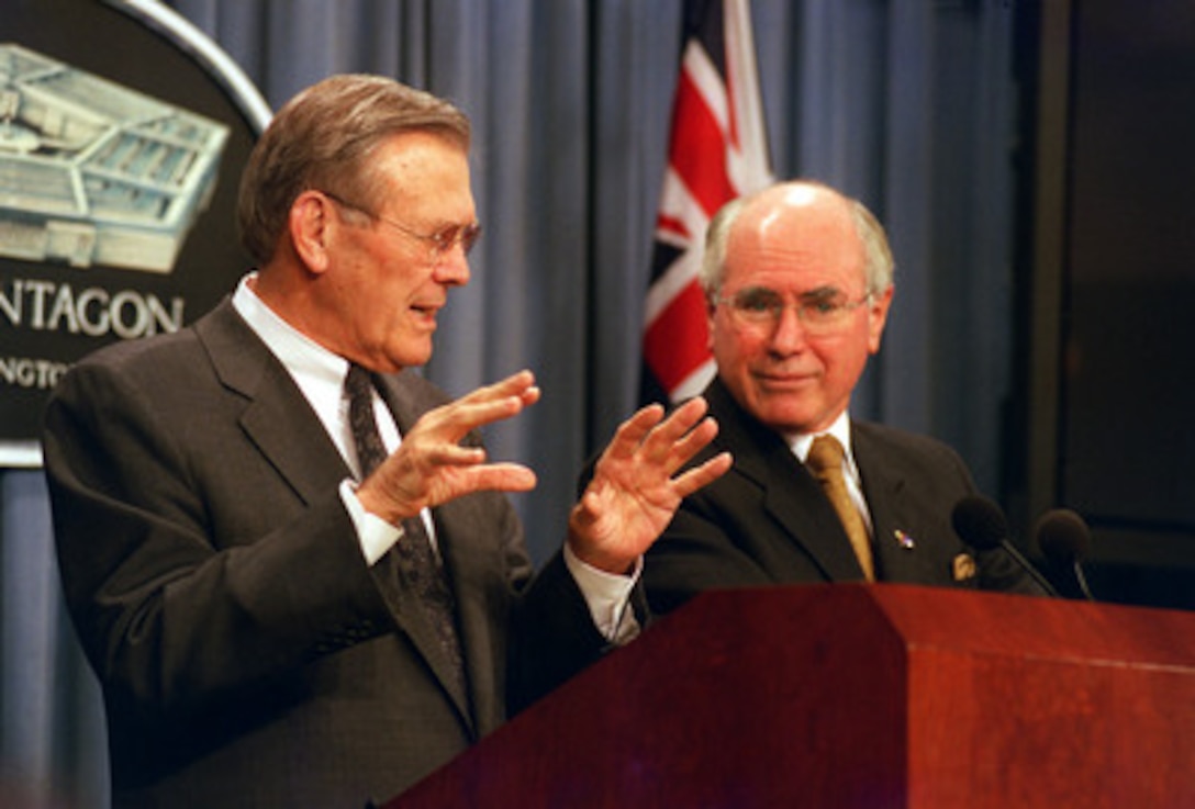 Secretary of Defense Donald H. Rumsfeld (left) responds to a reporter's question during a joint press conference with Australian Prime Minister John Howard (right) in the Pentagon on Feb. 10, 2003. Rumsfeld and Howard met earlier discuss a range of bilateral security issues including the situation in Iraq. 