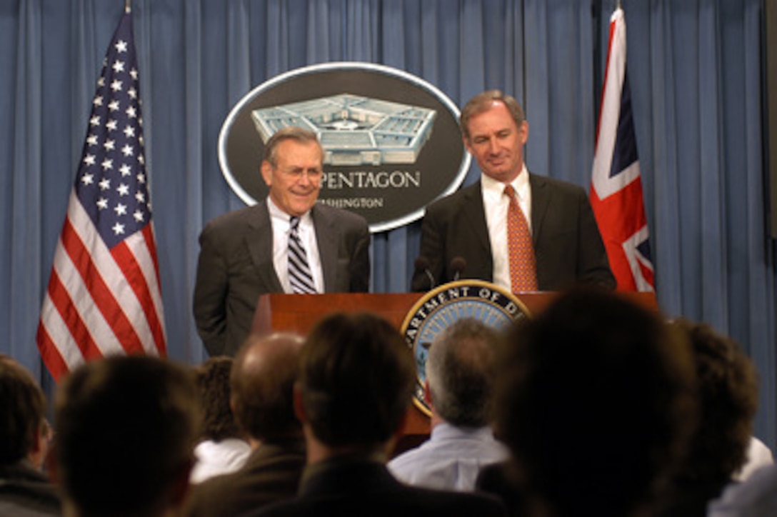 Secretary of Defense Donald H. Rumsfeld (left) and Britain's Secretary of State for Defence Geoffrey Hoon (right) listen to a reporter's question during a joint press conference in the Pentagon on Feb. 12, 2003. Rumsfeld and Hoon met earlier to discuss the war on terror and the situation with Iraq. 