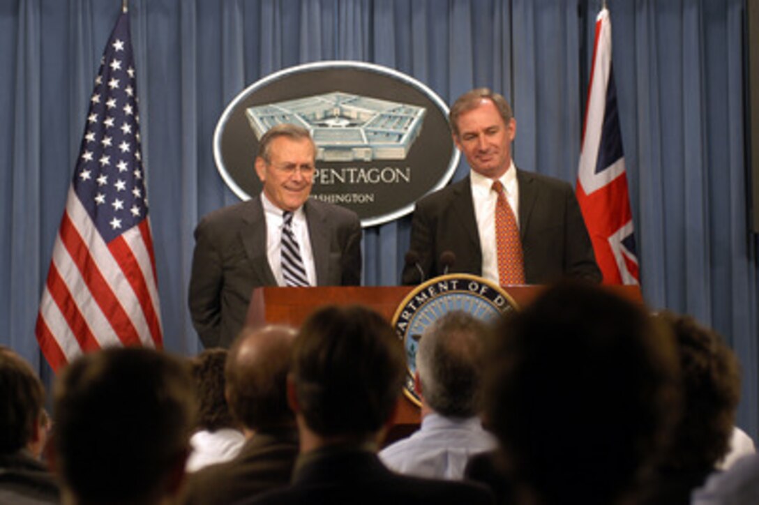Secretary of Defense Donald H. Rumsfeld (left) and Britain's Secretary of State for Defence Geoffrey Hoon (right) listen to a reporter's question during a joint press conference in the Pentagon on Feb. 12, 2003. Rumsfeld and Hoon met earlier to discuss the war on terror and the situation with Iraq. 