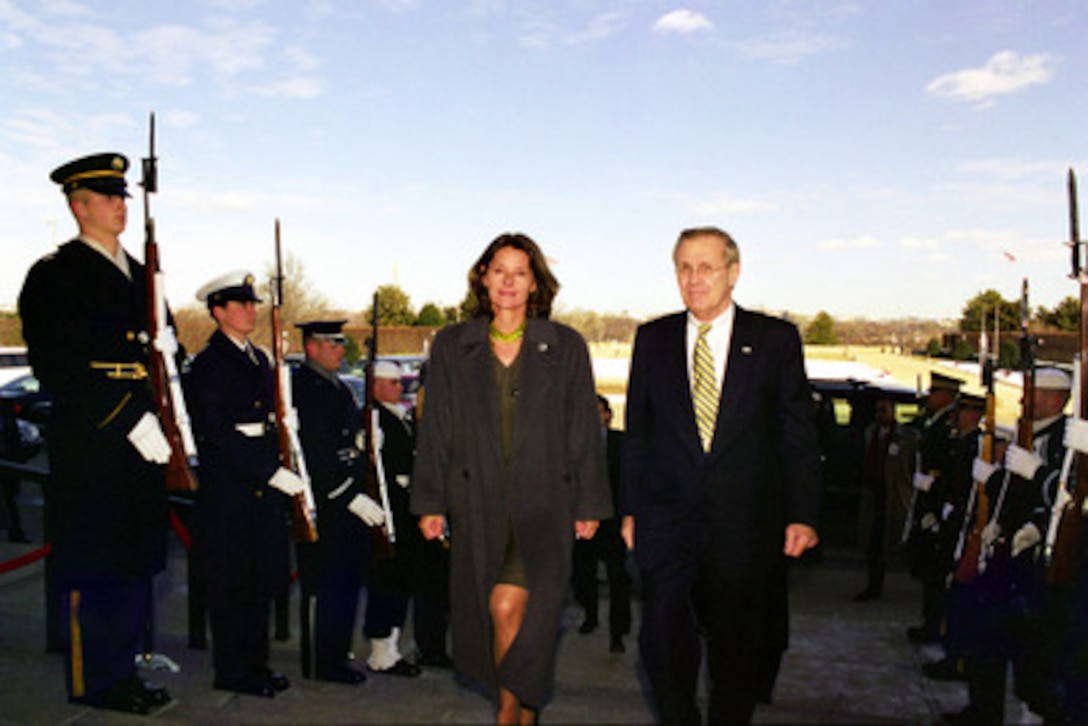 Secretary of Defense Donald H. Rumsfeld (right) escorts Colombian Minister of National Defense Marta Lucia Ramirez (left) through an honor cordon and into the Pentagon on Feb. 13, 2003. The two defense leaders are meeting to discuss defense issues of mutual interest. 