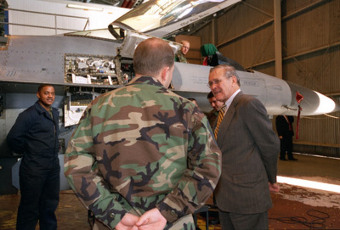 Secretary of Defense Donald H. Rumsfeld talks with U.S. Air Force maintenance personnel working on a F-16 Fighting Falcon at Aviano Air Base, Italy, on Feb. 7, 2003. Rumsfeld is visiting Aviano after meetings in Rome with Italian Prime Minister Berlusconi and Minister of Defense Martino. The Fighting Falcon belongs to the 555th Fighter Squadron, 31st Fighter Wing. 