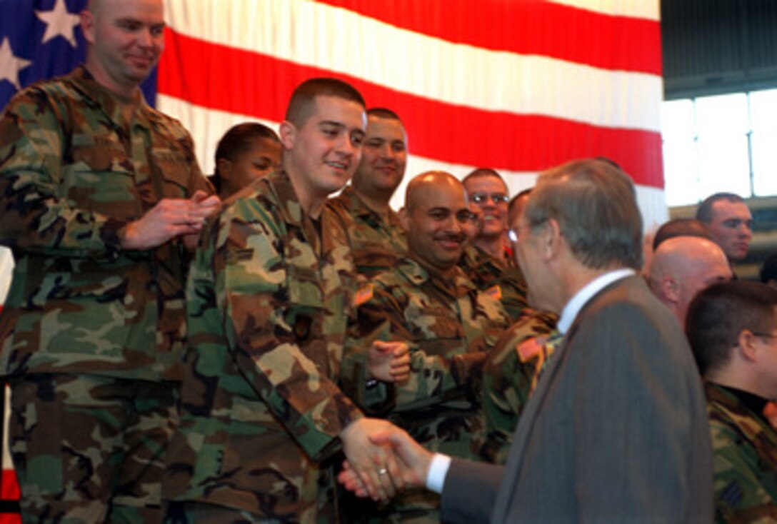 Secretary of Defense Donald H. Rumsfeld shakes hands with some of the airmen assembled for a town hall meeting at Aviano Air Base, Italy, on Feb. 7, 2003. Rumsfeld fielded questions from the audience of members of the U.S. Air Force 31st Fighter Wing. Rumsfeld is visiting Aviano after meetings in Rome with Italian Prime Minister Berlusconi and Minister of Defense Martino. 