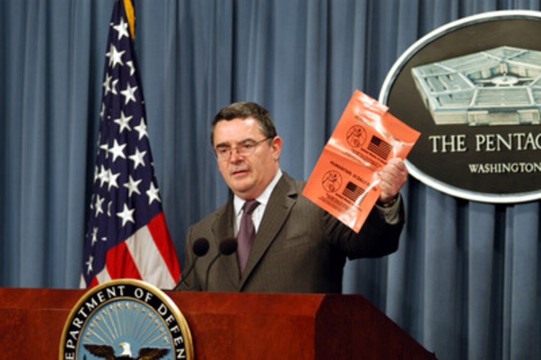 Deputy Assistant Secretary of Defense for Stability Operations Joseph Collins shows reporters the new vinyl wrapper for Humanitarian Daily Rations at a Pentagon news briefing on Feb. 25, 2003. Collins briefed reporters on some of the details of the humanitarian relief planning for Iraq should force become necessary. 