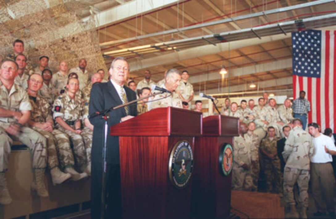 Secretary of Defense Donald H. Rumsfeld (left) and Gen. Tommy Franks, U.S. Army, listen to a question during a town hall meeting at As Sayliyah Military Camp, Qatar, on Dec. 12, 2002. Rumsfeld is in Qatar to meet with U.S. personnel at the Central Command forward headquarters and its supporting units. 