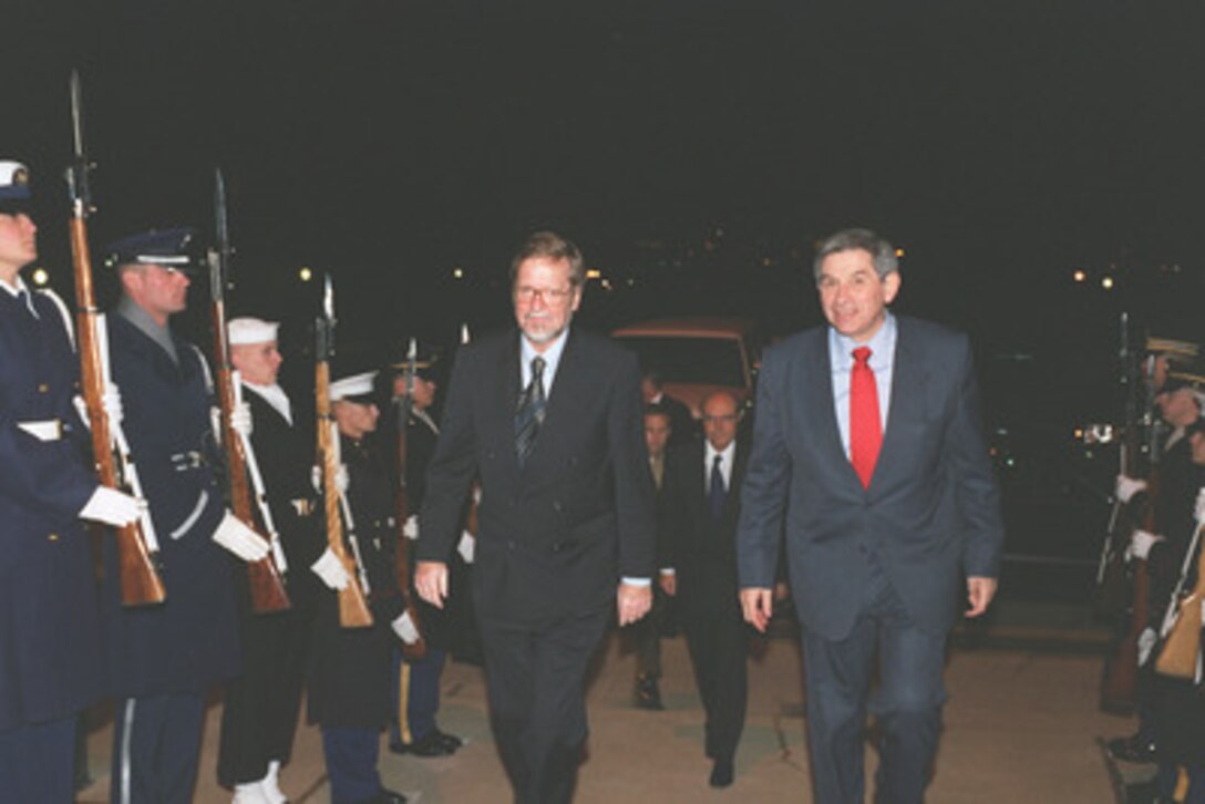 Denmark's Minister of Foreign Affairs Per Stig Moller (left) is escorted through an honor cordon and into the Pentagon by Deputy Secretary of Defense Paul D. Wolfowitz on Dec. 19, 2002. The two leaders will meet to discuss defense issues of mutual interest. 