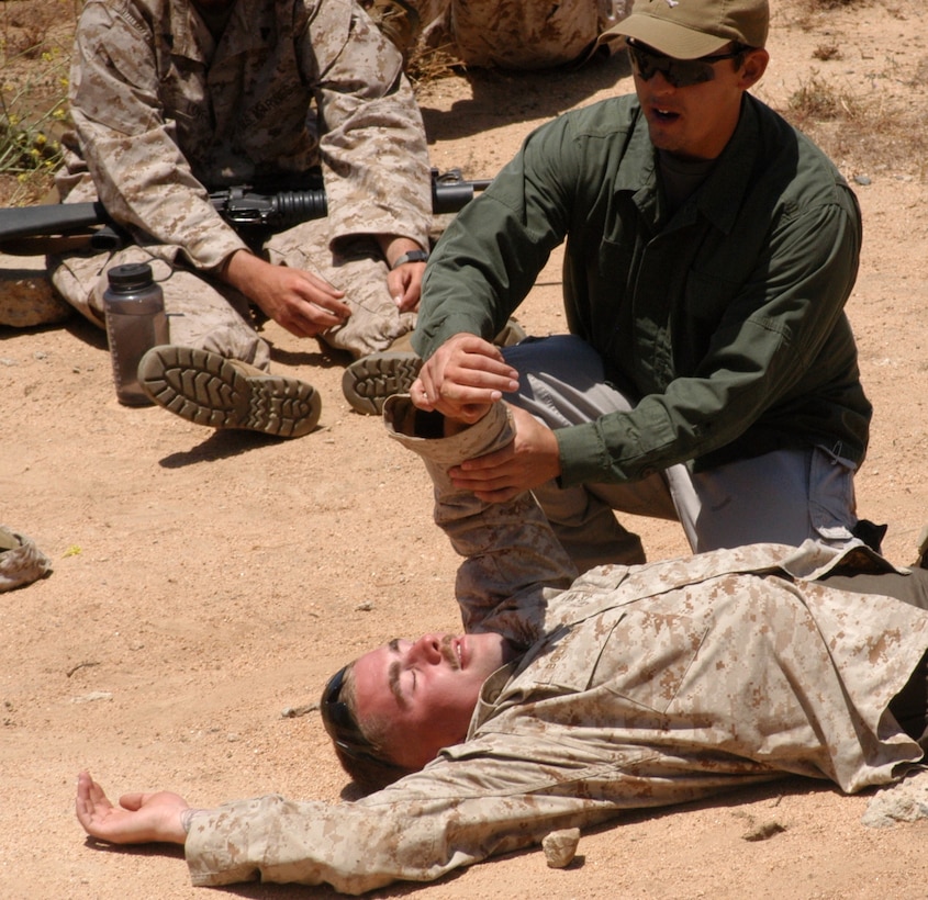 Carlos R., a Special Operations Training Services instructor, performs a conscious check on a volunteer from 1st platoon, Company L, 3rd Battalion, 25th Marine Regiment. Carlos, who was also a corpsman with Army and Marine Corps special forces, trained the Marines on combat trauma situations May 24 at the 25 Area Combat Town, Camp Pendleton, Ca. in preparation for the unit’s upcoming deployment to Afghanistan.