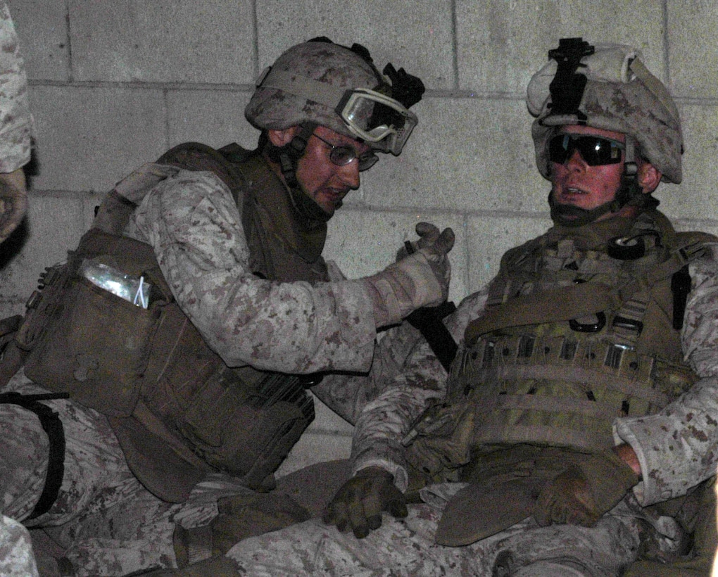 Cpl. James Aubin, a Cincinnati native, puts a tourniquet on Cpl. Mark Edwards, who was simulating being shot, while maneuvering through a military operations in urban terrain course May 24 at the 25 Area Combat Town, Camp Pendleton, Ca. 1st Platoon, Company L, 3rd Battalion, 25th Marine Regiment Marines practiced combat medical treatment in preparation for their upcoming deployment to Afghanistan.
