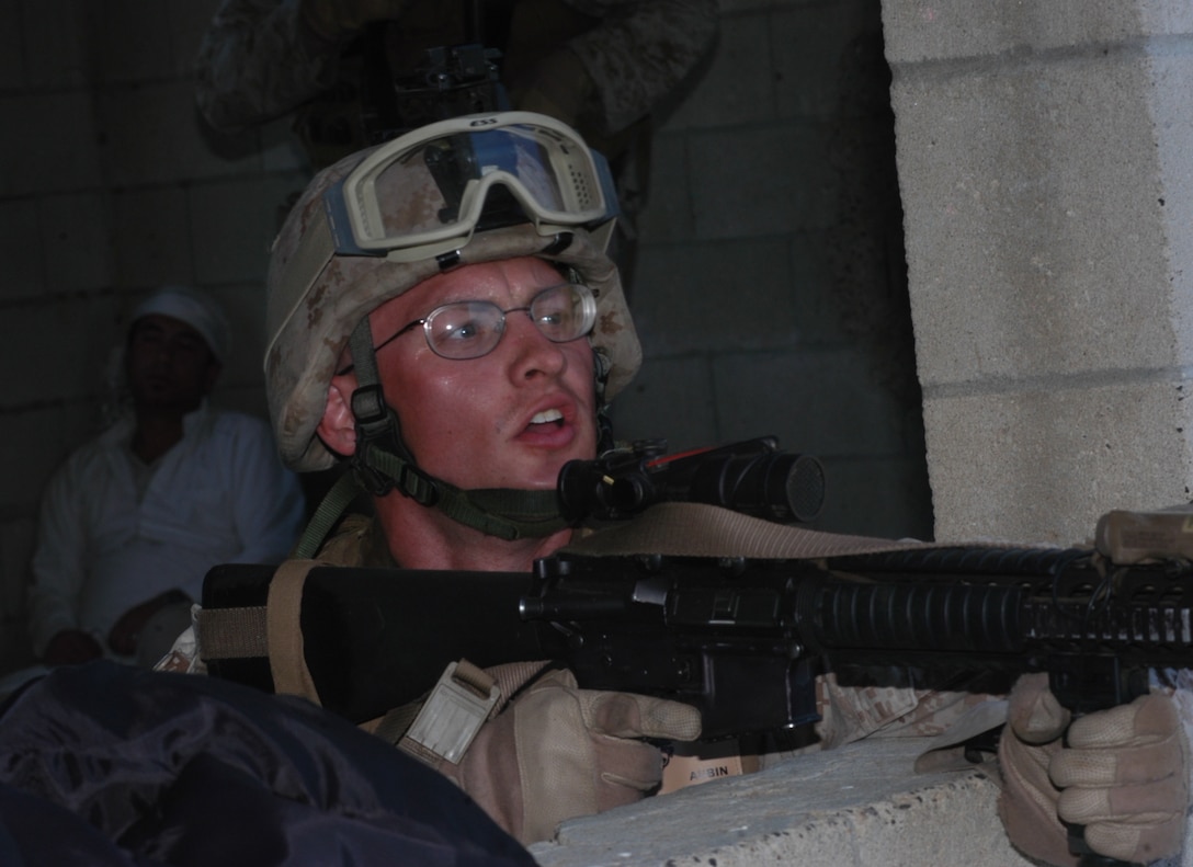 Cpl. James Aubin, a rifleman with 1st Platoon, Company L, 3rd Battalion, 25th Marine Regiment, searches for more enemies after clearing a room an role player was shooting from May 24 at the 25 Area Combat Town, Camp Pendleton, Ca. 1st Platoon Marines took fire from role players in preparation for their upcoming deployment to Afghanistan.